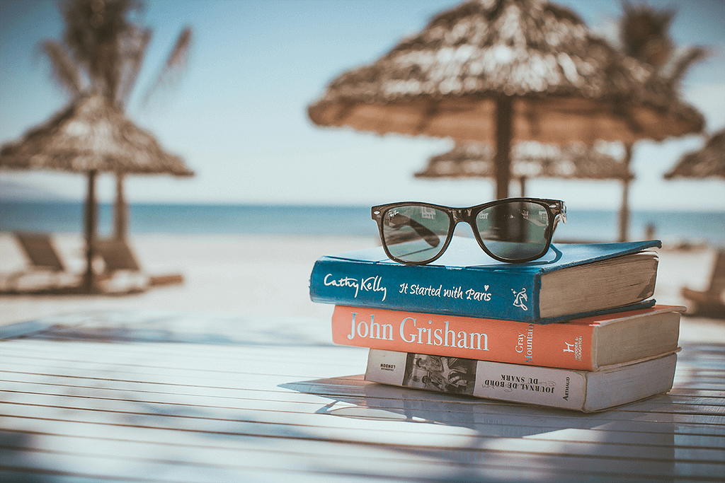 Books on a table near the beach