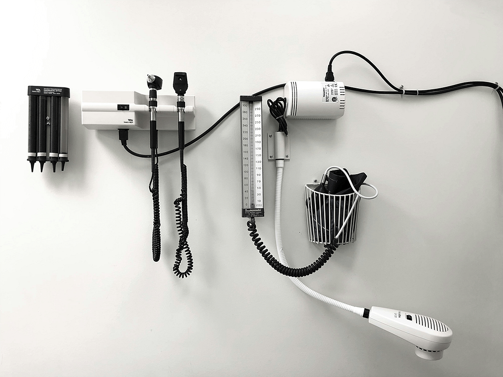 stethoscope and other medical instruments hanging on the wall